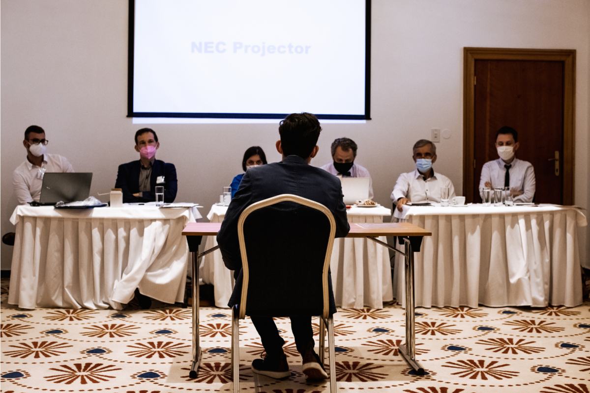 The expert jury and one of the finalists during the oral examination